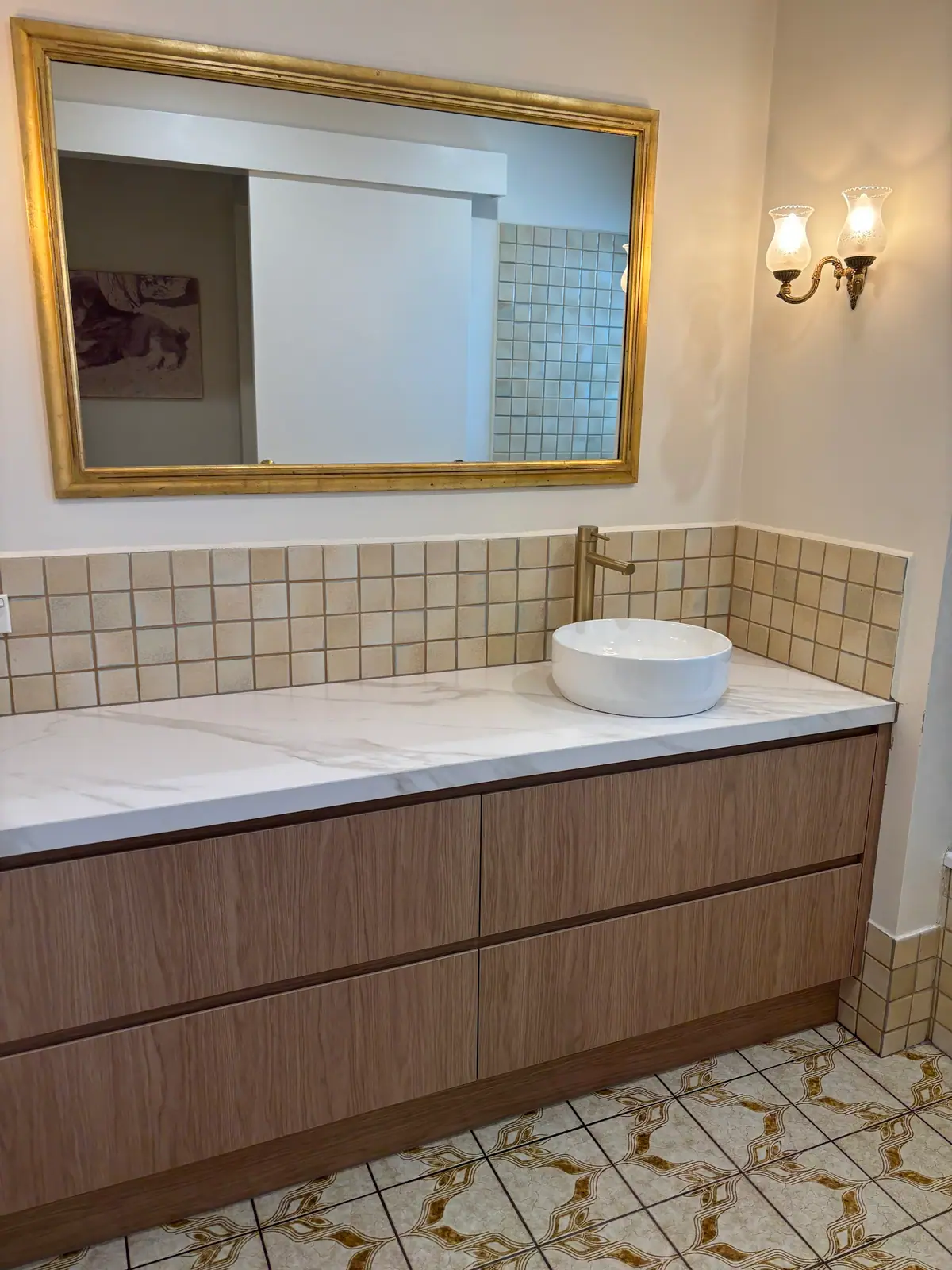 Detail of a full-width timber vanity with marble-look benchtop